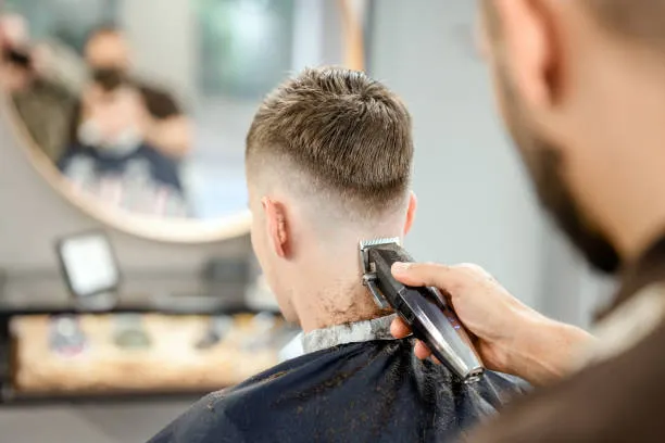 young-man-receiving-a-haircut-at-the-barber-shop